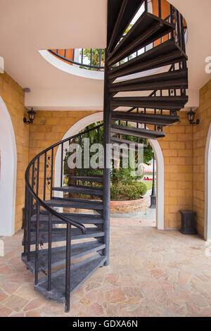view of a metal dark spiral staircase Stock Photo