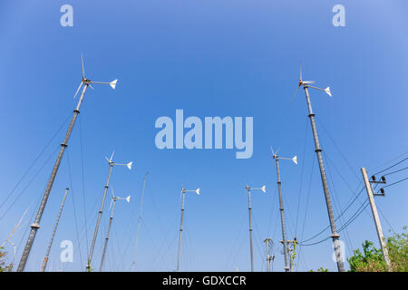 Wind turbines generating electricity on mountain with blue sky at Koh Larn, Pattaya, Chonburi, Thailand Stock Photo
