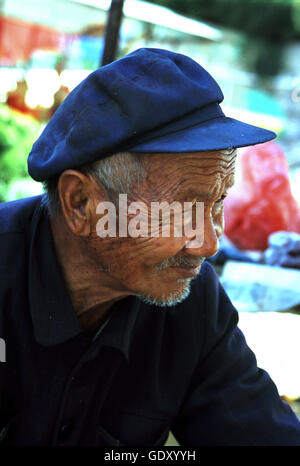 An elderly man at the Stone Forest in Lunan Yi Nationality Autonomous County. Yunnan Province in China. Stock Photo