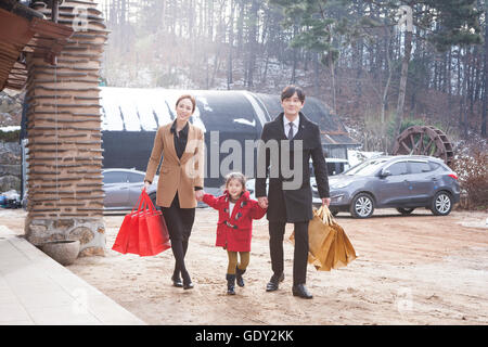 Happy family with shopping bags visiting their hometown Stock Photo