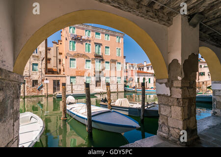 Chioggia glimpse from the arcades along the canals. Stock Photo