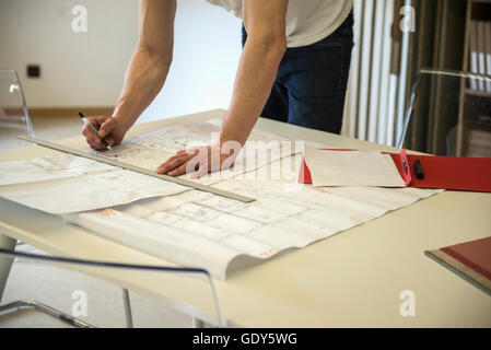 Midsection view of an architect making a blueprint in the office, Bavaria, Germany Stock Photo