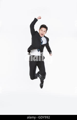 Business man in suit jumping into the air Stock Photo