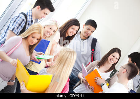 Group of college students standing together in the hallway. Stock Photo
