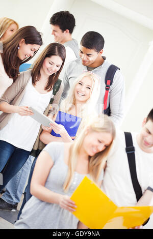 Large group of university students standing together in the hallway. Stock Photo
