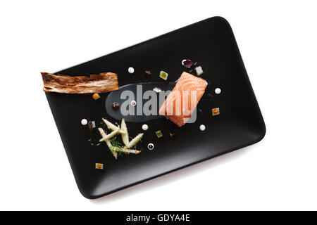 Molecular modern cuisine red fish in a dish with beautiful garnish close up. Isolated Stock Photo