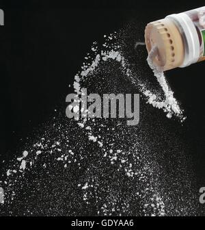 Icing Sugar Sprinkled against Black Background Stock Photo