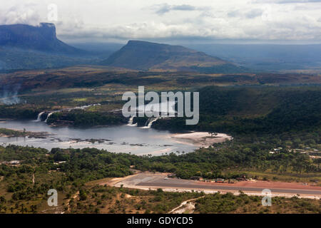 Aerial view of Canaima Lagoon waterfalls at river Carrao in Venezuela. Tepuis (table mountains) in the background Stock Photo