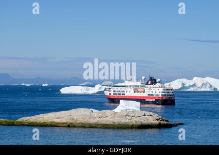 Hurtigruten MS Fram expedition explorer cruise ship moored offshore amongst icebergs in Disko Bay on west coast in summer 2016. Ilulissat, Greenland Stock Photo