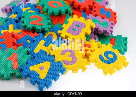 Alphabet and number puzzle pieces Stock Photo