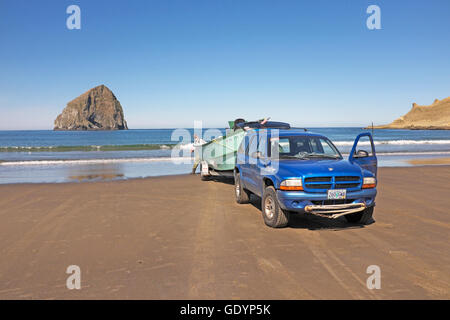 A dory fisherman stands near his boat on the beach at Pacific City, Oregon, home of the Pacific city Dory Fleet. Pacific City is Stock Photo