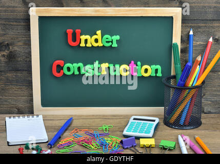 Under construction word on school board Stock Photo