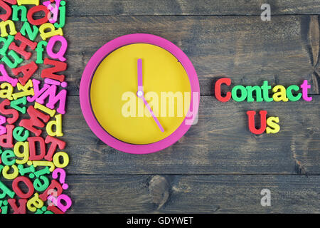 Contact us word on wooden table Stock Photo