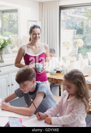 Mother and daughter doing homework at dining table Stock Photo - Alamy