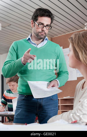 Teacher scolding student because of her bad result in classroom, Bavaria, Germany Stock Photo