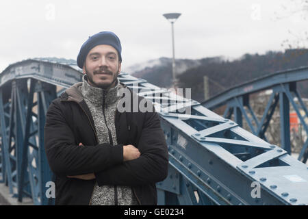 Portrait of a mid adult man standing with arms crossed, Freiburg im breisgau, Baden-württemberg, Germany Stock Photo