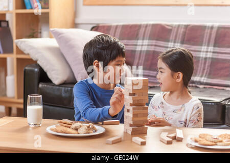 Side view portrait of smiling boy and girl playing a game together Stock Photo