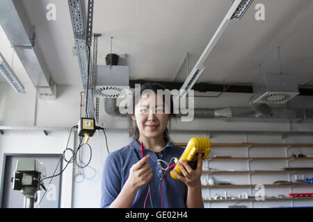 Young female engineer working  with multimeter in an industrial plant, Freiburg Im Breisgau, Baden-württemberg, Germany Stock Photo