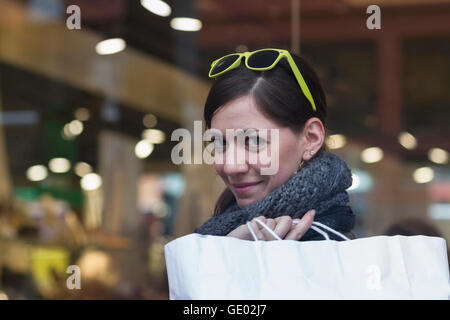 Portrait of a young woman with shopping bag in the shop, Freiburg im Breisgau, Baden-Württemberg, Germany Stock Photo