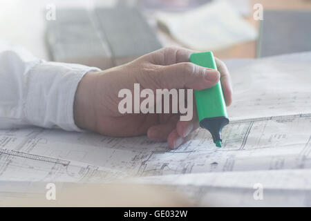 Cropped image of a businessman with highlighter working on blueprint in the office, Freiburg im Breisgau, Baden-Württemberg, Germany Stock Photo