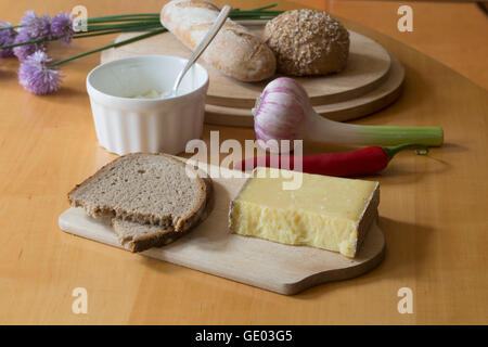 Brown bread slice with vegetables on table in the kitchen Stock Photo