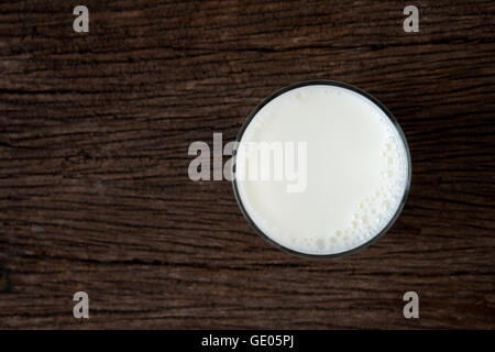 milk glass top view on old wood background Stock Photo