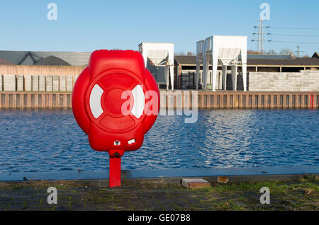 Safety life buoy in red case in a harbor Stock Photo