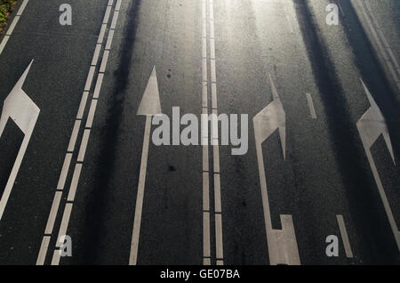 high point of view on a multi lane asphalt road with white arrows Stock Photo