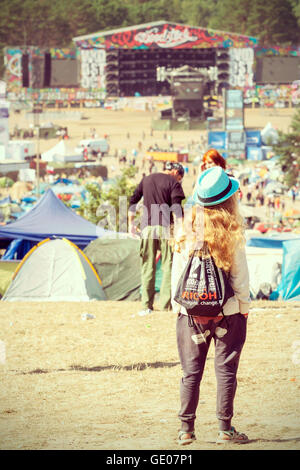 Young woman looking at the main stage on the 21th Woodstock Festival Poland. Stock Photo