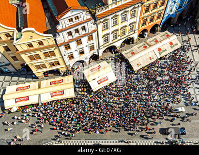 PRAGUE, CZECH REPUBLIC - JUNE 12, 2014:  Aerial view of tourists watching Astronomical Clock (Orloj) in the Old Town of Prague. Stock Photo