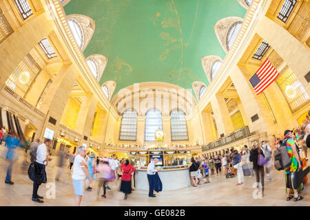Fisheye lens picture of people and commuters in motion by the famous clock in the Grand Central Terminal. Stock Photo