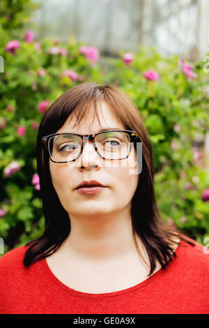 pretty modern mature fat woman outside wearing glasses, emotional