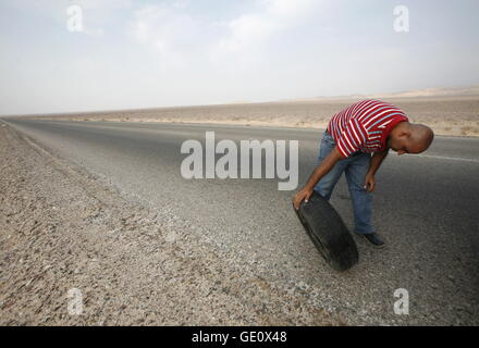 A flat tire on a Taxi on the Desertroad 65 near the Towns Safi and Aqaba in Jordan in the middle east. Stock Photo
