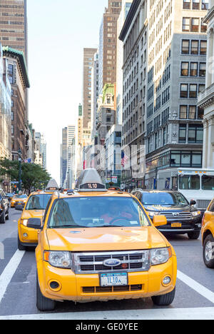 New York City, USA - August 15, 2015: City cabs waiting in a traffic on street of Manhattan. Yellow cab is one of NY symbols. Stock Photo