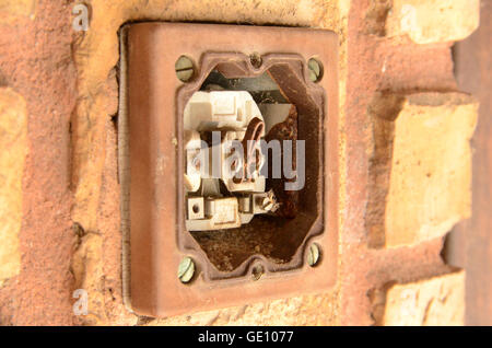 Defective light switch that will cause shock hazard. This switch is found in a School Yard. Stock Photo