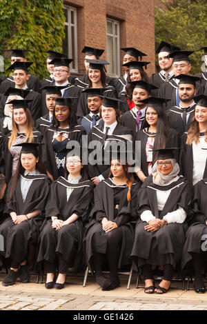 Graduates from many different cultures graduating from University of Birmingham, Birmingham UK - Concept - Multicultural Britain Stock Photo