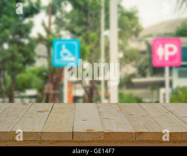 wood table top on blur of sign in gas station - can use to display or montage on products Stock Photo