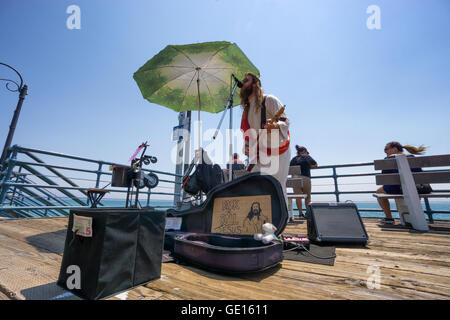 SANTA MONICA, USA - JUNE 19: street musician sings and plays guitar dressed in Jesus costume on the Santa Monica pier Stock Photo
