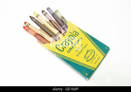 A vintage 8 pack of Crayola crayons with seven crayons sticking out on a white background. Stock Photo