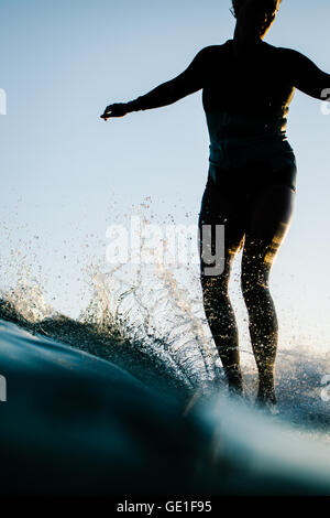 Close-up of woman surfing, Malibu, California, United States Stock Photo