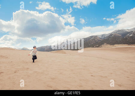 Boy running, Great sand dunes national park, Colorado, United States Stock Photo