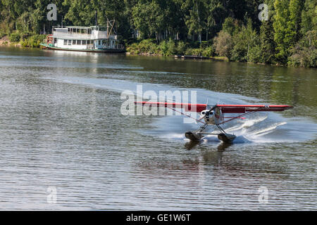 Float plane landing on Chena River at Fairbanks AK Stock Photo