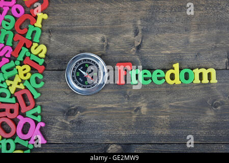 Freedom word on wooden table Stock Photo