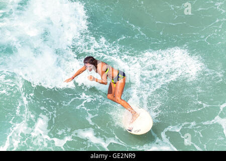 Venice, California, USA - August 22, 2015: Young woman surfing at Venice Beach on a beautiful sunny day. Stock Photo