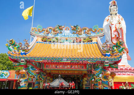 Chinese dragon on the roof and guanyin with blue sky in thailand Stock Photo