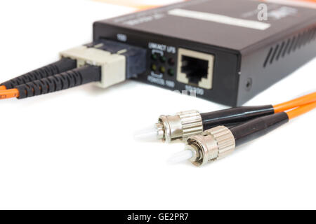 Close up metal fiber optic cable In front media converter Stock Photo