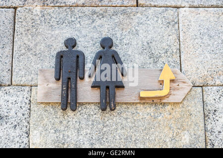 Wooden sign on the wall of toilet Stock Photo