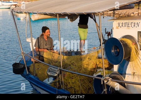 A fisherman prepares his nets in his boat on July 10, 2016 in Petalidi of Peloponnese, Greece. Stock Photo
