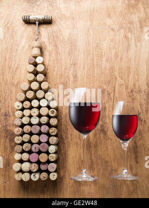 Wine corks in the shape of wine bottle on the wooden background. Stock Photo
