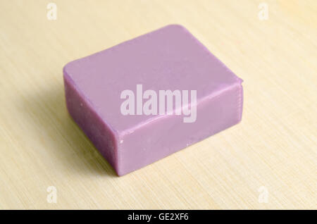 Lavender natural extract soap bar isolated on wooden board background Stock Photo